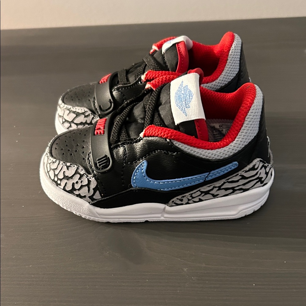Nike Kids Black and Red Sneakers with Blue Swoosh